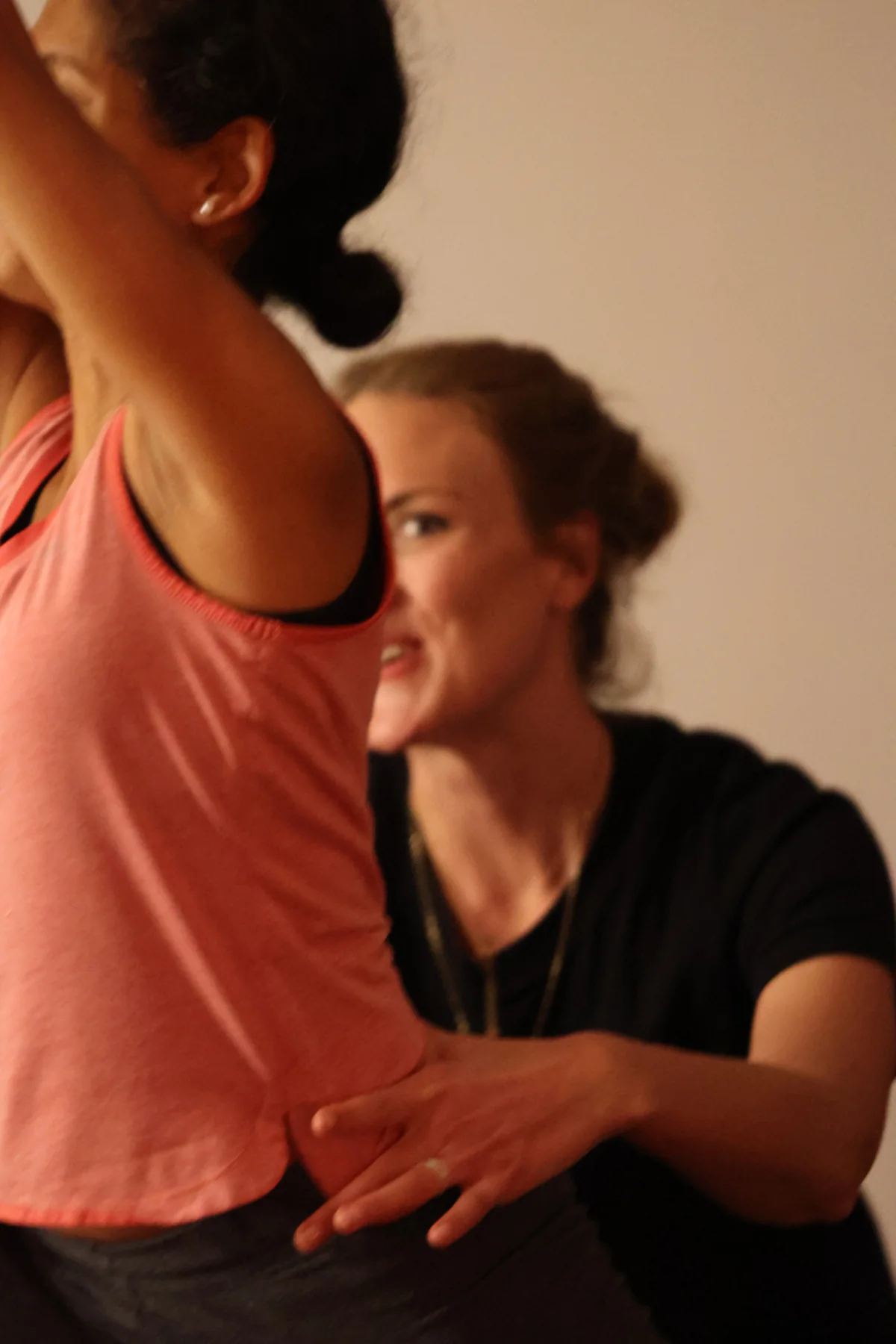 A teacher talking a participant through a movement