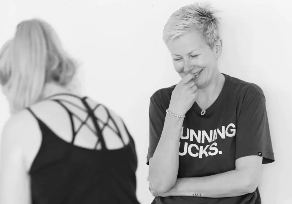 Two participants laughing during a team session